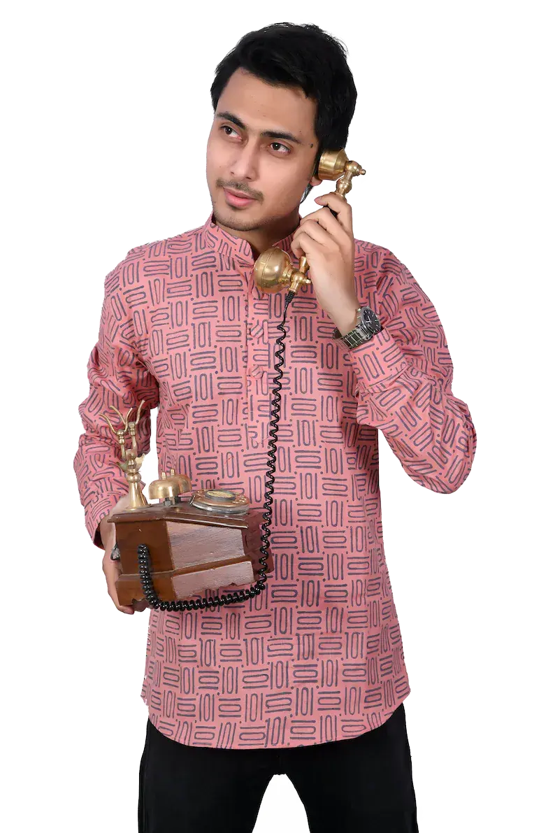 Faizaan Salar in a pink block-print kurta, holding the receiver of a brass rotary phone